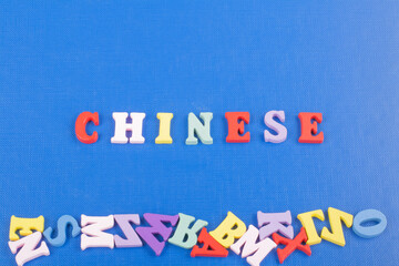 CHINESE word on blue background composed from colorful abc alphabet block wooden letters, copy...