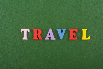 Obraz premium TRAVEL word on green background composed from colorful abc alphabet block wooden letters, copy space for ad text. Learning english concept.