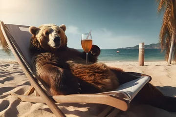 Fototapeten brown bear lying on sun bed and drinking a cocktail in summer sunny sea beach © dobok