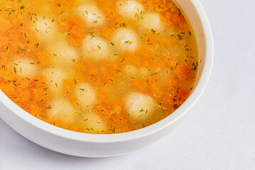 soup with meatballs on white background