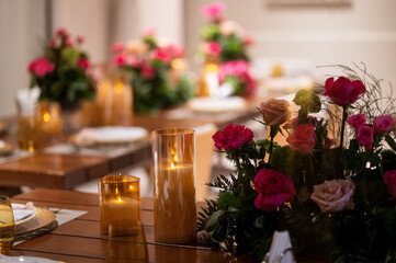 Beautiful tables served for a dinner with flowers and candles. interior decorations, festive, holidays, celebration, restaurant