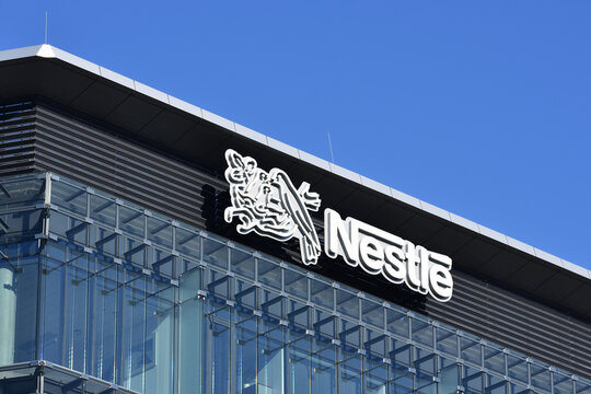 Nestle office with logo, signage, emblem on the facade, Swiss food and drink company. WARSAW, POLAND - NOVEMBER 1, 2021