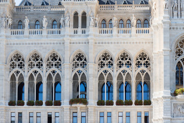 Fototapeta na wymiar Details of the facade in the architecture of Austria. The unusual wall of the Town Hall in Vienna. Window framing in Austria.
