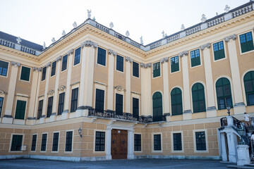Entrance to the palace. A tall building with columns and statues on the roof. Facade of the royal palace. Austrian architecture.