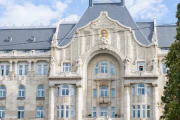 Stylish architecture of a European city. Gray geometric roof. Square roof of the palace. Stylish architecture with high columns and arches. Decorated courtyard facade.