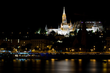 Fototapeta premium A tall castle on a hill. Night Budapest. Beautiful panorama of a big city in Europe. European city Budapest. Sights and attractions of Hungary.