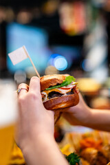 woman hands holding fresh delicious burger