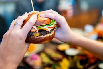 woman hands holding fresh delicious burger