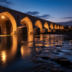 iran ancient bridge over river at blue hour night.