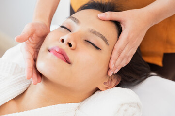 Face massage. Close-up of calm young woman getting spa massage treatment at spa salon.. - 727076353