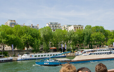 Travel in summer on a river boat along the Seine River in the center of Paris and see the sights,...