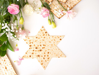 Passover. Traditional Matzo shape of star Magen David  decorate by pink flowers on white...
