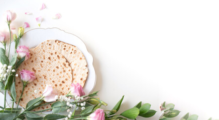 Passover. Holiday of Jewish people. Traditional Matzo prepared for Passover decorate by flowers on...