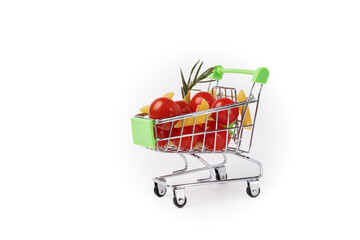 Grocery cart filled with Italian food, pasta and tomato, white background, supermarket purchase