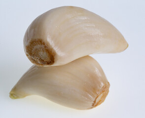 Two garlic cloves on white 
