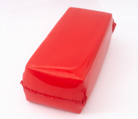 Cheese in red shrink bag  on white 