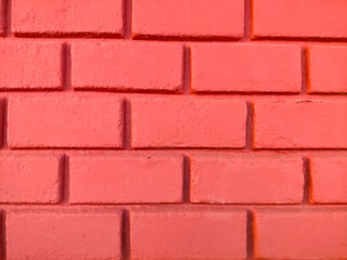 exposed brick wall background freshly painted reddish-pink urban style
