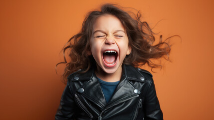 little cute girl in a black leather biker jacket screams on a color background in the studio, children, child, childhood, teenager, kid, schoolgirl, fashion, style, rock, space for text, rocker, rebel - obrazy, fototapety, plakaty