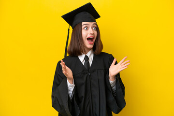 Young university graduate Ukrainian woman isolated on yellow background with surprise facial expression
