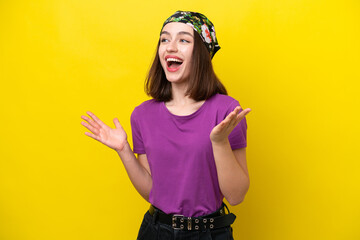 Young Ukrainian woman isolated on yellow background with surprise facial expression
