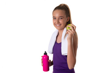 Healthy lifestyle - fitness girl eating apple smiling happy looking at camera and holding a water bottle. Pretty Caucasian woman isolated