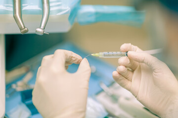 Detail of a dentist performing surgery with anesthesia on a patient for root canal treatment and regeneration. No people are recognizable. - 727125367