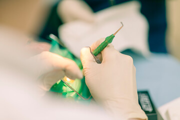 Detail of a dentist performing surgery with anesthesia on a patient for root canal treatment and regeneration. No people are recognizable. - 727125393