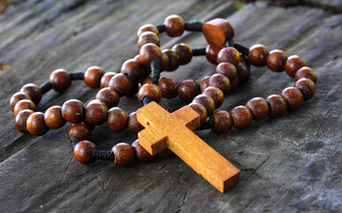 Holy Rosary on wooden table. Christianity and prayer concept