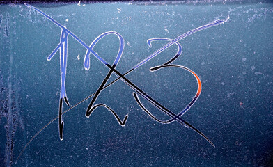 hand written numbers Winter frozen back car window, texture freezing ice glass background, - 727142141