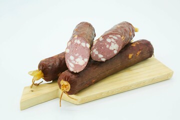 Meat dish sausage on a wooden board. The product is ready to use. White background.