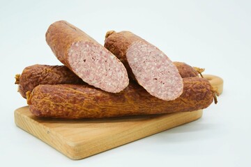 Meat dish sausage on a wooden board. The product is ready to use. White background.