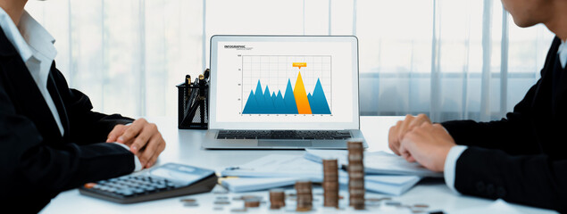 Business intelligence analyst use BI software on laptop to analyze financial data dashboard with...