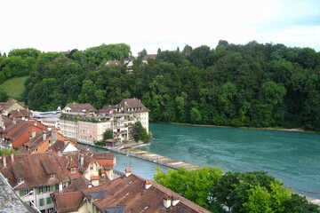 Fototapeta na wymiar Panoramic view of river Aare and rooftops houses at old historical center town in Bern, Switzerland.