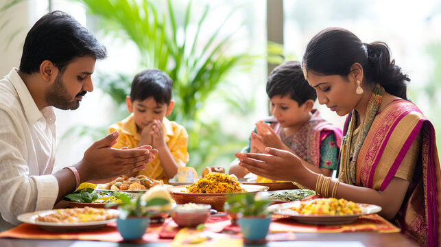Indian family on dining table doing prayer before eating - Powered by Adobe