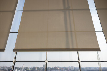 white curtain or white blinds Roller sun protection in office with river view background.