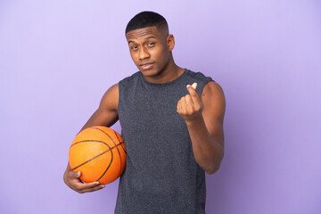 Young basketball latin player man isolated on purple background making money gesture