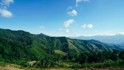 Beautiful sunshine at misty morning mountains of Thailand. Rainforest ecosystem and healthy environment concept background, Texture of green tree forest view from above.