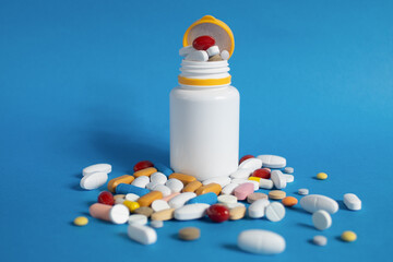 Close-up, Pills scattered on the table. Many pills of different colors and shapes