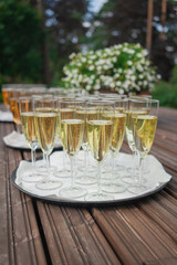 Glasses of champagne on a table in the garden. Selective focus.