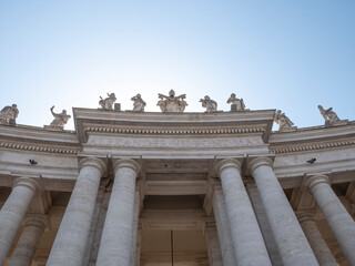 Statues of saints and apostles on colonnade of St. Peter's basilica, Vatican city, Italy. Horizontal view