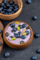 fresh blueberry-flavored yogurt with ripe blueberries and pistachios