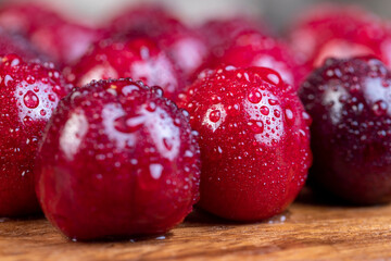 covered with drops of water ripe red cherries on the table