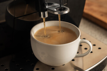 Modern espresso coffee machine with a cup closeup.