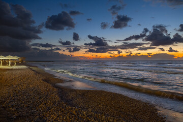 seashore with dramatic clouds at sunset in Haifa