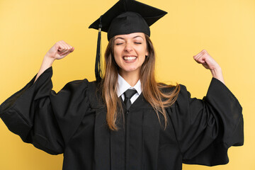 Young university graduate isolated on yellow background doing strong gesture