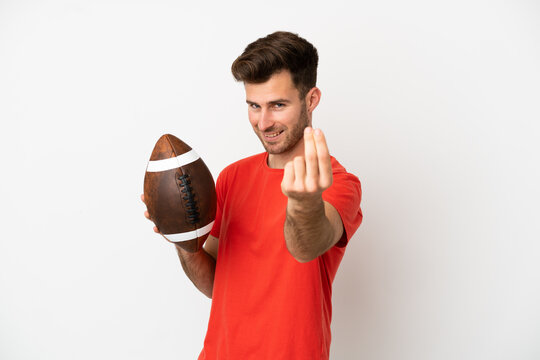 Young caucasian man playing rugby isolated on white background making money gesture