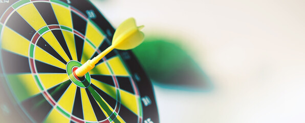 Bullseye target goal or dartboard has dart arrow throw hitting center shooting for financial business targeting planning to winner concept.