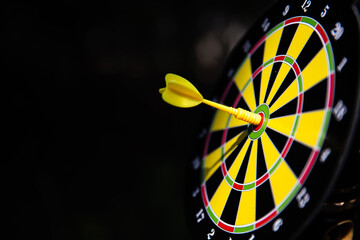 Bullseye target goal or dartboard has dart arrow throw hitting center shooting for financial...