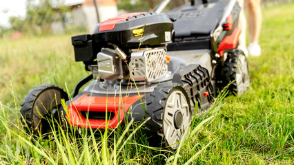 Obraz premium lawn mower on a mowed lawn