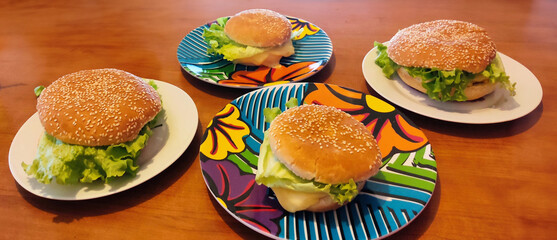 Home cooked burgers, cheeseburger and hamburger on the table.